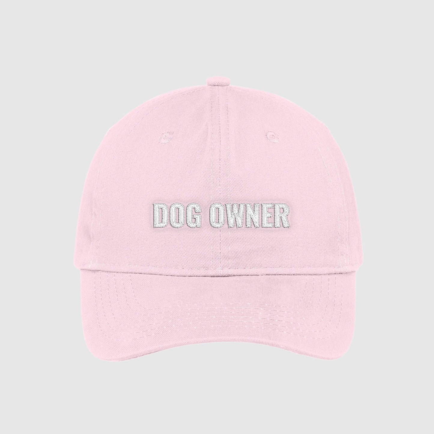 Blush light pink dad hat with Dog Owner embroidered on the front with white thread.
