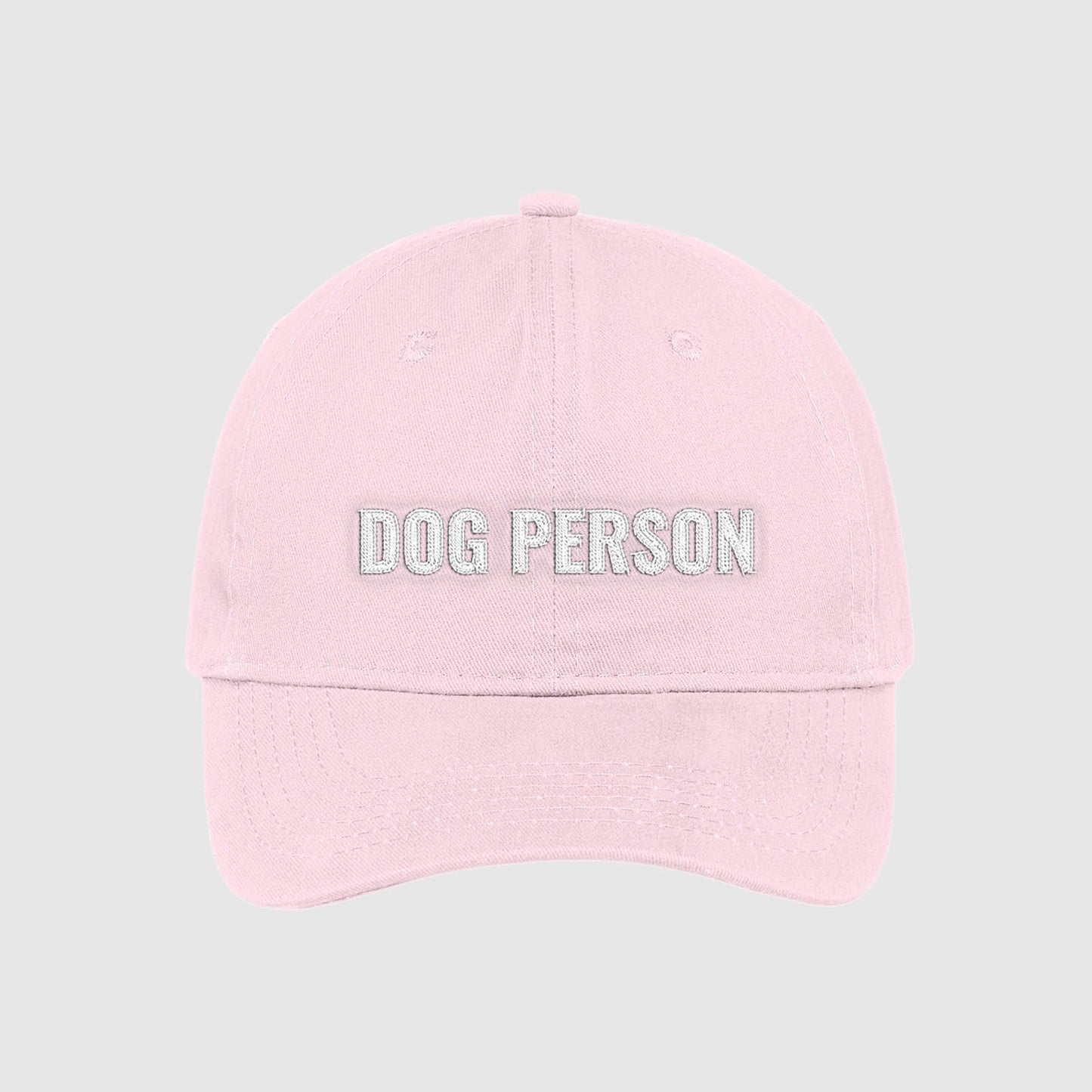 Blush light pink dad hat with Dog Person embroidered on the front with white thread.