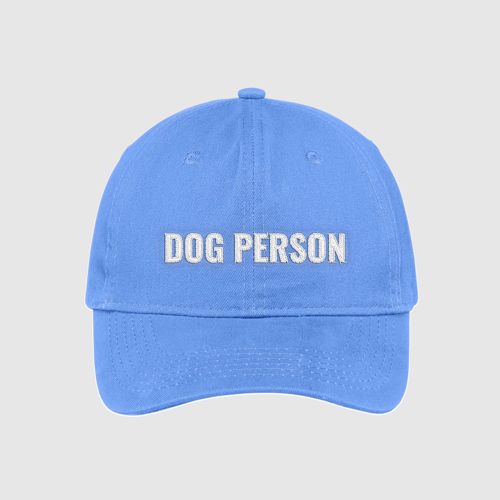 Carolina blue baby blue dad hat with Dog Person embroidered on the front with white thread.