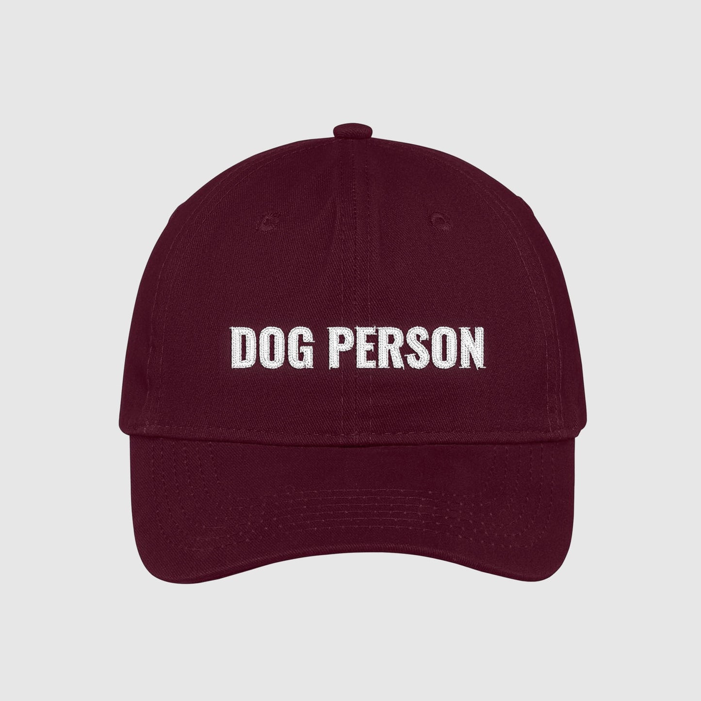 Maroon dad hat with Dog Person embroidered on the front with white thread.